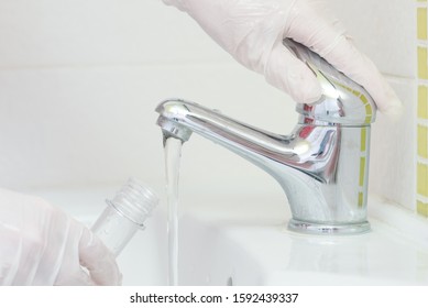 Tap Water Analysis Quality Control Concept. Hand With A Flask And Water Tap Ckose Up.