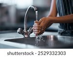 Tap, water and hands for hygiene, skincare and cleaning or bacteria disinfection by kitchen sink. Faucet, woman and washing palms in restaurant with splash for virus, dirt and health and protection