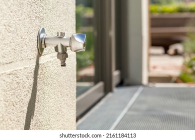 Tap Water On Outside Wall. Outdoor Garden Faucet On Yard Background. 