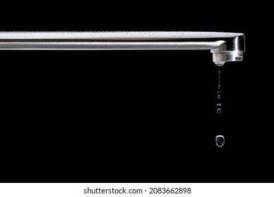 tap with waterdrop against black background.
