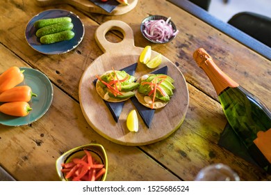 Tapas appetizer on a table with vegetables and cava