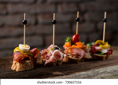 Tapas on Crusty Bread - Selection of Spanish tapas served on a sliced baguette.