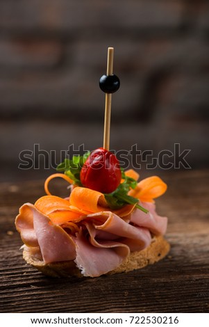 Tapas on Crusty Bread - Selection of Spanish tapas served on a sliced baguette.