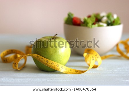 tape and lettuce on a light background. Slimming, diet, healthy food.
