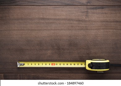 tape measure on the brown wooden background