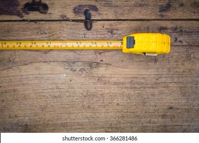 tape measure on the brown wooden background - Shutterstock ID 366281486