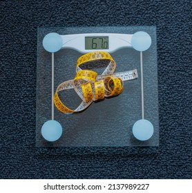 Tape Measure On A Glass Scale Which Marks 67 Kg, Dark Gray Carpet In Background