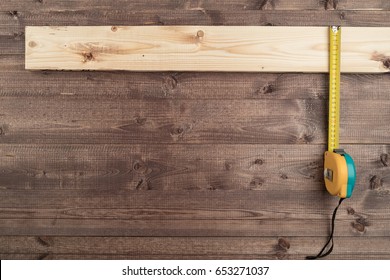 A tape measure on a wooden table - Shutterstock ID 653271037