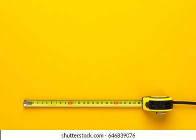 Tape Measure On The Yellow Background With Copy Space