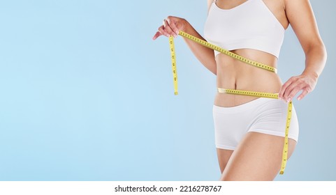 Tape measure, stomach and woman health diet, fitness and detox weight goals, target and abdomen on mockup blue background. Liposuction, tummy tuck and wellness model, bmi progress and skinny body fat