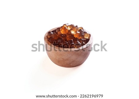 Tapioca Pearls (Bubble Tea) on wooden bowl isolated on white background, It's small chewy balls made from tapioca starch, Commonly used as a topping in milk tea drinks.
