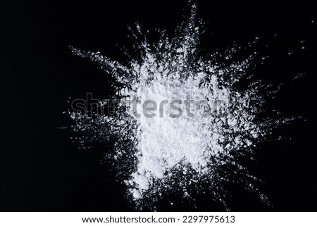 Tapioca starch or flour powder. Heap of tapioca starch in the form of an explosion on a black background. Top view.