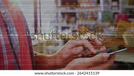 Tapping smartphone at cafe table with hands in red blue plaid shirt, overlaying financial graphs. Technology, data visualization, casual workspace, finance, mobile device, modern design, analysis