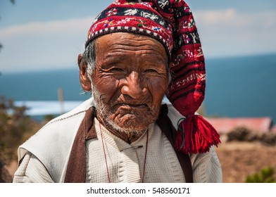 TAQUILE ISLAND, PUNO, PERU - OCTOBER 13, 2016: Close Up Portrait Of Old Peruvian Man Dressing Traditional Knitted Hat