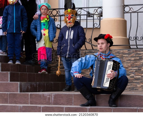 Taraclia, Moldova,10.03.2019. Socialization of\
people with disabilities. A man with down syndrome in a national\
costume and with an accordion. Inclusion (disability\
rights).Carnival of\
mummers.
