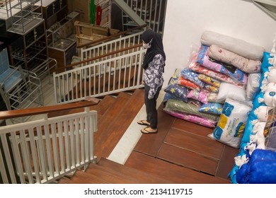 Tarakan, Indonesia, March 5 2022: Two Women Wearing Hijab Who Are Descending The Stairs In An Interior Shop That Contains Tables And Chairs, In Designing Interior Furniture Is Quite Important