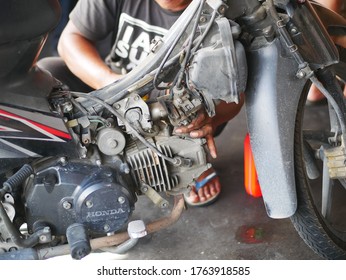 Tarakan/Indonesia-June 26,2020: An Indonesia man is repairing the carburetor of the motorcycle. - Shutterstock ID 1763918585