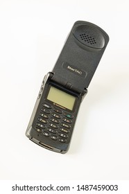 Taranto, Italy - 24 August 2019: The Historic GSM Motorola Startac Mobile Phone Photographed On A White Background, Slightly Inclined, Vertical Image.