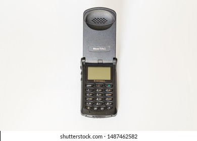 Taranto, Italy - 24 August 2019: Historic Mobile Gsm Motorola Startac Photographed On A White Background In The Center Of The Frame, Flip Open.