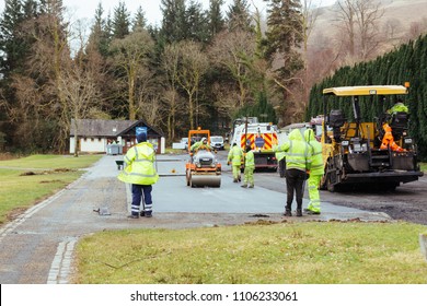 Tarbet, Scotland/UK - 03.17.2018: Road workers asphalting car park in Tarbet village near Loch Lomond in Scotland, UK