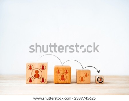 Target audience concept. Arrow jumping from big group to small goal target, cube blocks with human and community icon on white background. Niche market, customer segment, consumer marketing concepts.