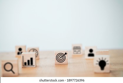 Target board with arrow print screen on wooden cube block to setup objective target and investment goal. - Shutterstock ID 1897726396