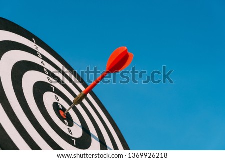 Target dart and arrow with abstract nature bokeh blur background