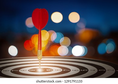 target dart with arrow over blurred bokeh background ,metaphor to target marketing or target arrow concept. - Shutterstock ID 1291791133