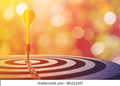 target dart with arrow over blurred bokeh background ,metaphor to target marketing concept. - Shutterstock ID 381212347