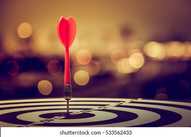 target dart with arrow over blurred bokeh background ,metaphor to target marketing or target arrow concept.