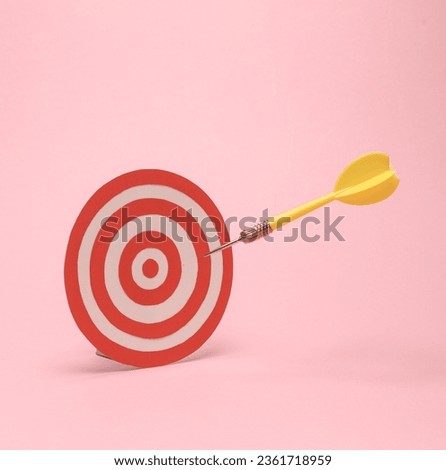 Target with darts on a pink background. Business concept. Minimalism