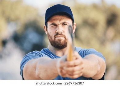 Target, focus and axe throwing with man in nature and aim for sports, training and tomahawk skills. Exercise, goal and hunting with athlete and hatchet in range for bullseye, ready and competition