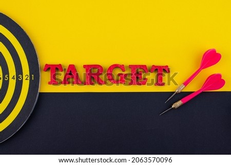 Target and goal concept with darts and arrows on color background