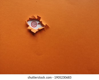 Target Icon Underneath An Orange Color Background Showing Hidden Target Meaning