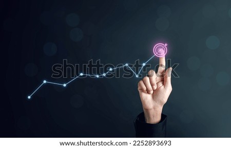  Target icon which for planning development leadership and customer target group concept. Businessman touching business target on virtual screen, set goals for better results.