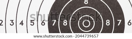 Target for shooting. Black and white banner or headline on the subject of shooting sports. Fragment of training target. Warm tones