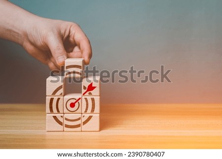 Targeting business goal concept. Business man put wood block down complete Target and goal for success, project management, leadership, success, strategy, prospect, sustainable goal, target objective.
