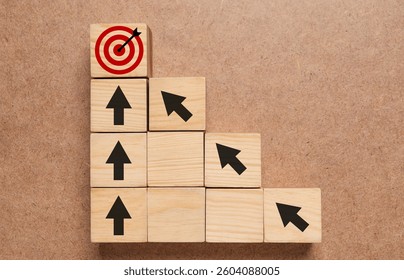 Targeting. Cubes with arrows pointing at one with bullseye on wooden background, top view