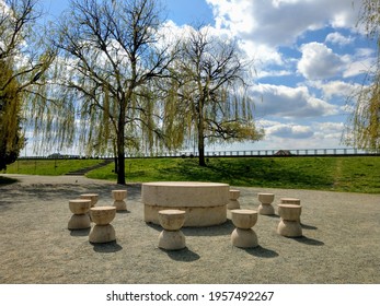 Targu Jiu, RO - April 16, 2021: Table of Silence (Masa Tacerii) from the Sculptural Ensemble of Constantin Brancusi. Spring view of hourglass shaped chairs and round stone table. UNESCO heritage site.