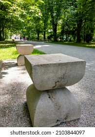 Targu Jiu, RO - May 23, 2021: Alley of Chairs and Gate of the Kiss by Constantin Brancusi. Sculptural ensemble situated in the city central park. Beautiful spring view of european patrimony monuments 