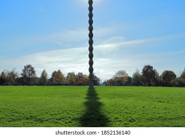 Targu Jiu, Romania - November 7, 2020: Endless Column from the Sculptural Ensemble of Constantin Brancusi. Homage to the Romanian heroes of the First World War. Artistic view point from its shadow.