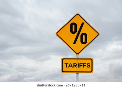 Tariffs. Sanctions and tariff increases, creative idea. Yellow tariffs sign on gray cloudy sky, concept. 