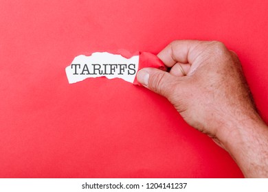 Tariffs word message written on ripped pieces of cardboard paper