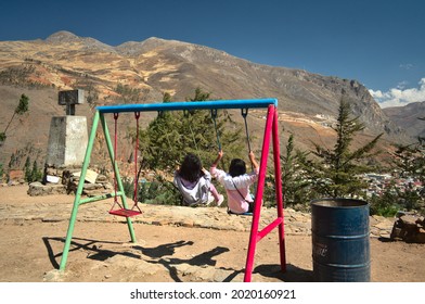 Tarma, Perú; August 03 2021, 2 Girl Playing On The Swing, In A Summer Camp In The Mountains