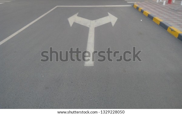 Tarmac\
(asphalt) road with road signs and symbols  painted by White color\
painted and posted as shutter stock\
images