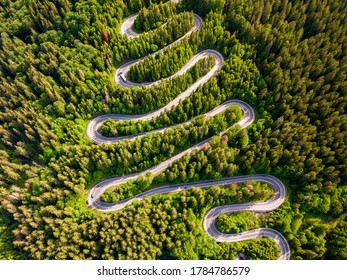 Tarmac Road Seen From Above. Aerial View Of An Extreme Winding Road Through Middle Of The Forest