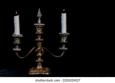 Tarnished Silver Double Candle Burning Candelabra Isolated On Black With Copy Space