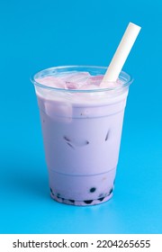A Taro Boba Tea on a Bright Blue Background - Shutterstock ID 2204265655