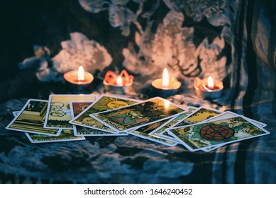 Tarot Card With Candlelight On The Darkness Background For Astrology Occult Magic Illustration / Magic Spiritual Horoscopes And Palm Reading Fortune Teller Concept