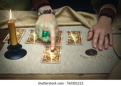 Tarot Cards And Fortune Teller Desk Table. Future Reading. Woman Fortune Teller Shows With Her Index Finger On Tarot Card.